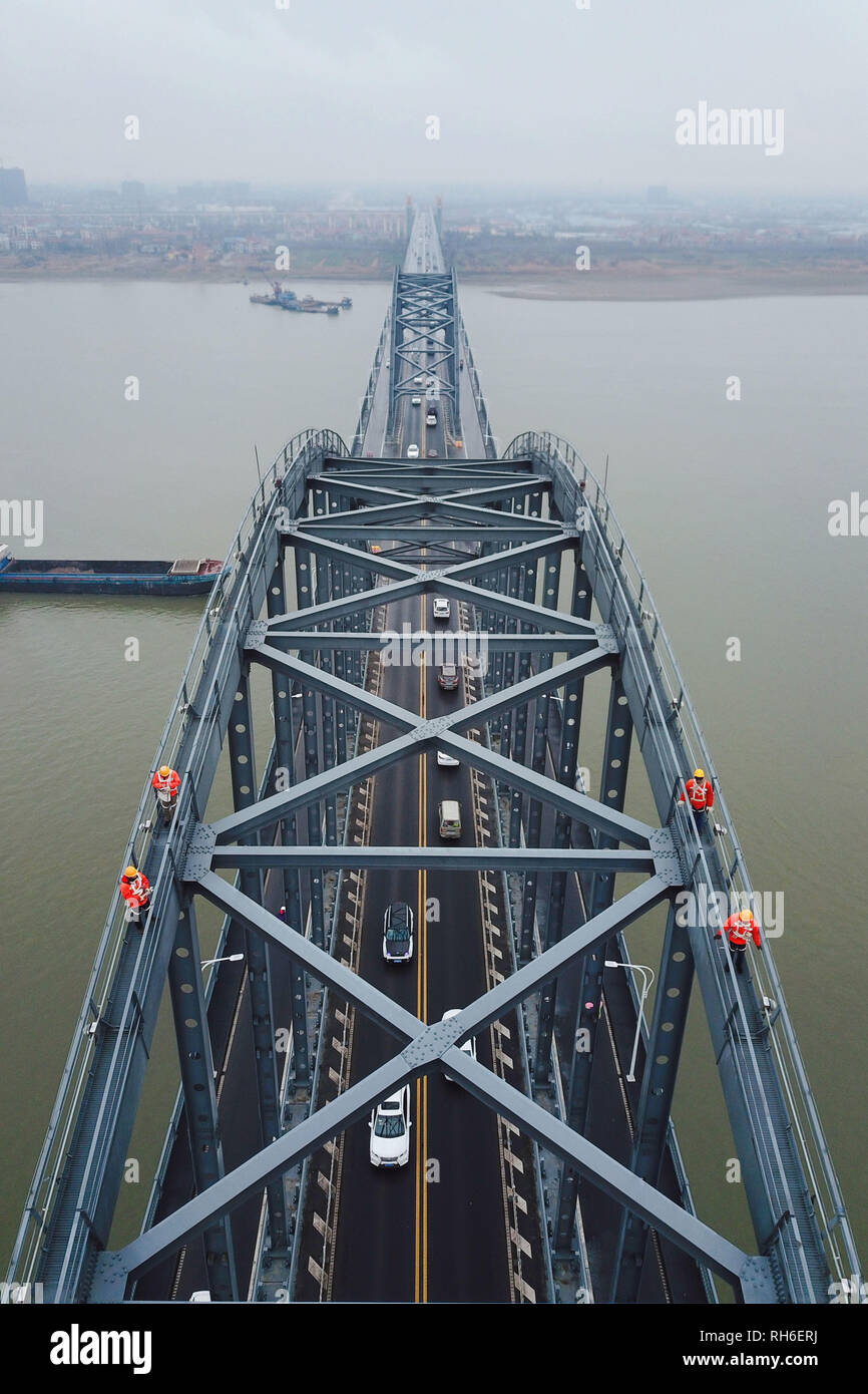 (190201) -- JIUJIANG, Feb. 1, 2019 (Xinhua) -- Aerial photo taken on Jan. 31, 2019 shows bridge workers checking the Jiujiang Yangtze River Bridge, a double-decked road-rail truss bridge and an important section of Beijing-Kowloon (Jingjiu) Railway in Jiujiang, east China's Jiangxi Province. Safety inspections have been strengthened to secure transportation during the 2019 Spring Festival travel rush. (Xinhua/Ding Bo) Stock Photo