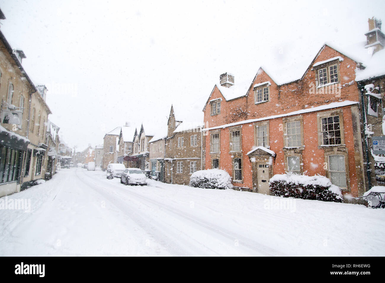 Corsham, Wiltshire, UK. 1st February, 2019. Heavy snowfall blankets the ancient town centre, home to the TV series Poldark and now a wintery scene which was forecast, though arrived late and much heavier than earlier predictions. Local residents brave the cold conditions as heavy snowfall continues to accumulate   throughout the day - with revised forecasts reporting sustained snow until 6pm this evening. The roads   are empty of cars, many schools and business remain closed whilst the wintery weather continues it's icy   grip in Wiltshire. Credit: Wayne Farrell/Alamy Live News Stock Photo