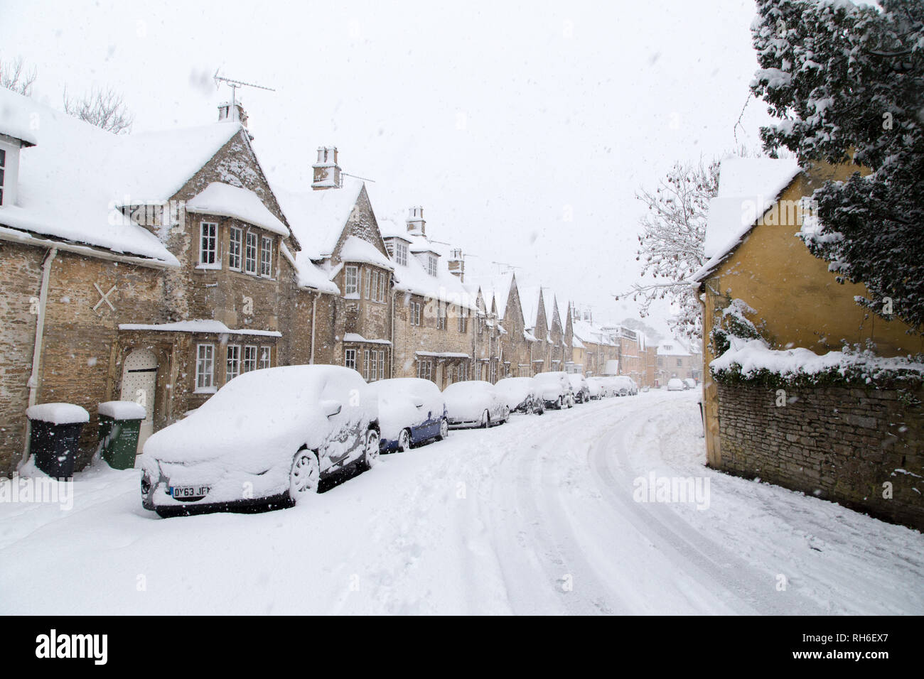 Corsham, Wiltshire, UK. 1st February, 2019. Heavy snowfall blankets the ancient town centre, home to the TV series Poldark and now a wintery scene which was forecast, though arrived late and much heavier than earlier predictions. Local residents brave the cold conditions as heavy snowfall continues to accumulate   throughout the day - with revised forecasts reporting sustained snow until 6pm this evening. The roads   are empty of cars, many schools and business remain closed whilst the wintery weather continues it's icy   grip in Wiltshire. Credit: Wayne Farrell/Alamy Live News Stock Photo