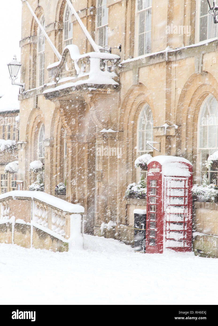 Corsham, Wiltshire, UK. 1st February, 2019. Heavy snowfall blankets the ancient town centre, home to the TV series Poldark and now a wintery scene which was forecast, though arrived late and much heavier than earlier predictions. Local residents brave the cold conditions as heavy snowfall continues to accumulate   throughout the day - with revised forecasts reporting sustained snow until 6pm this evening. The roads   are empty of cars, many schools and business remain closed whilst the wintery weather continues it's icy   grip in Wiltshire. Credit: Wayne Farrell/Alamy Live News Stock Photo