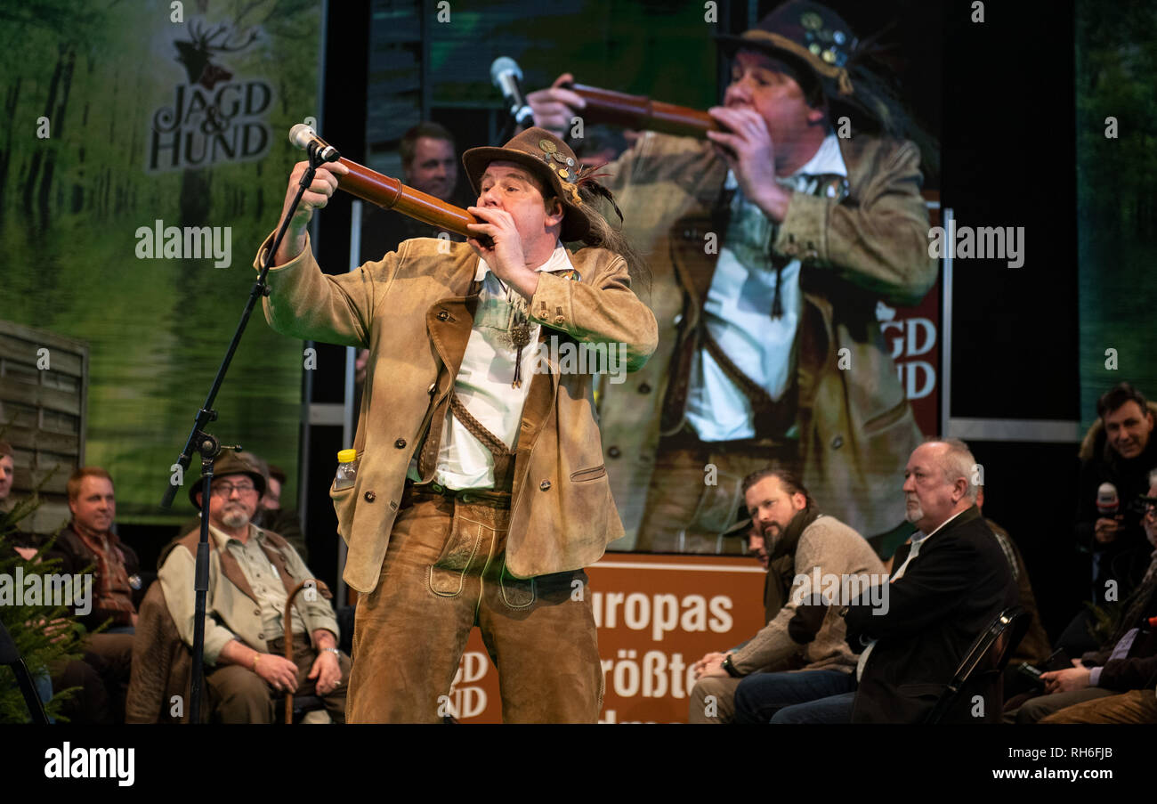 Dortmund, Germany. 01st Feb, 2019. Immo Ortlepp from Wedemark blows into  his instrument at the 21st German Stag Caller Championship. The event  belongs to the annual highlight of the fair "Jagd &