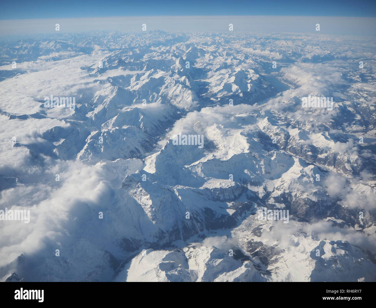 Aerial landscape of the Alps in Europe during winter season with fresh snow. View from the window of the airplane Stock Photo