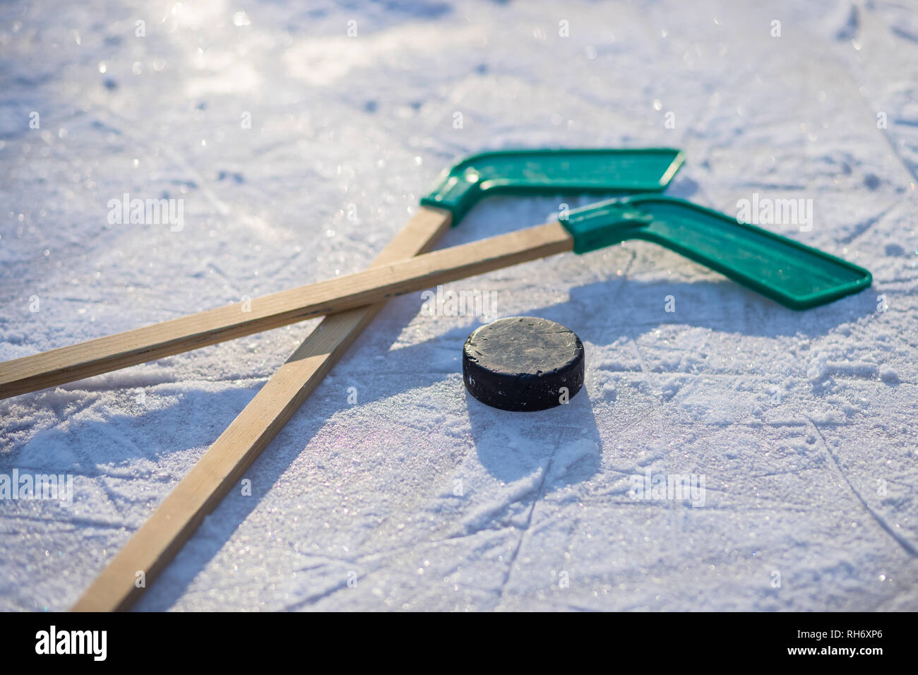 ice hockey stick with white tape and puck. team game, competition