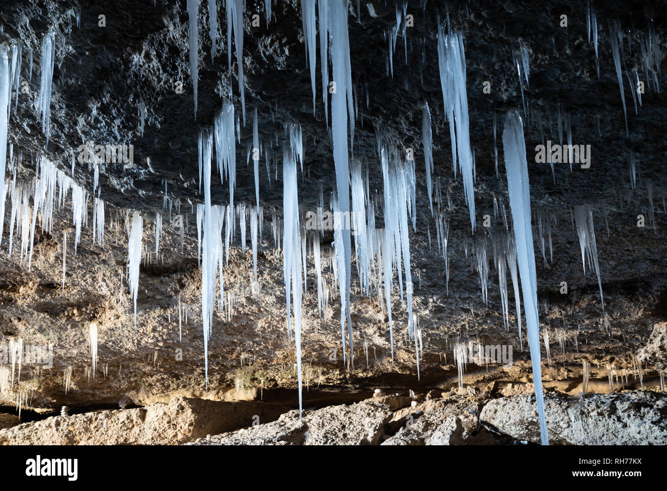 Many Icicles Hanging From The Ceiling Of The Cave Stock