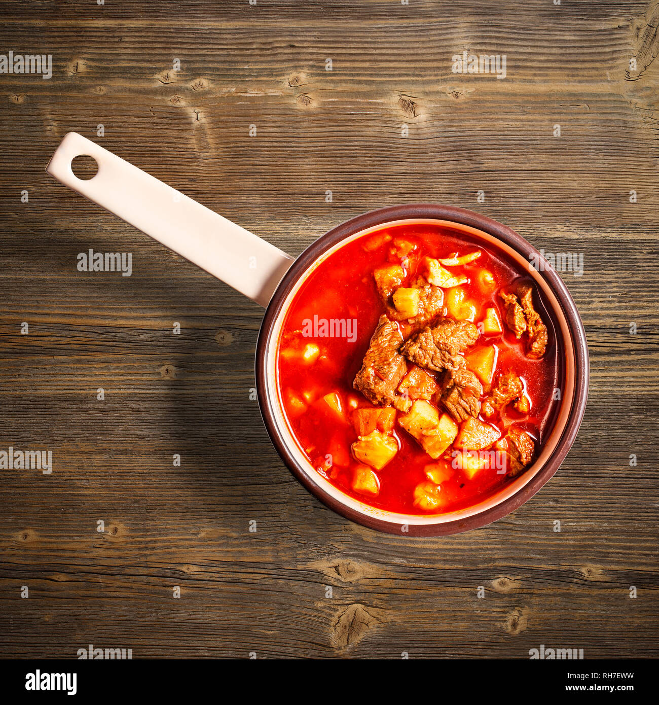 Flat lay of goulash soup on wooden background Stock Photo