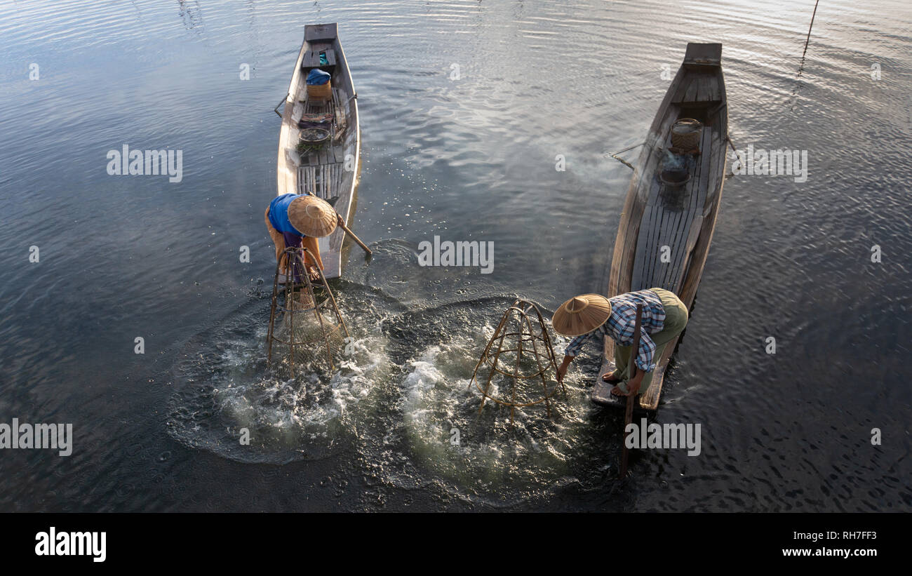 Lake Inle/ Myanmar- January 12,2019: traditional Intha fisherman in long boat in the early morning on Lake Inle Stock Photo