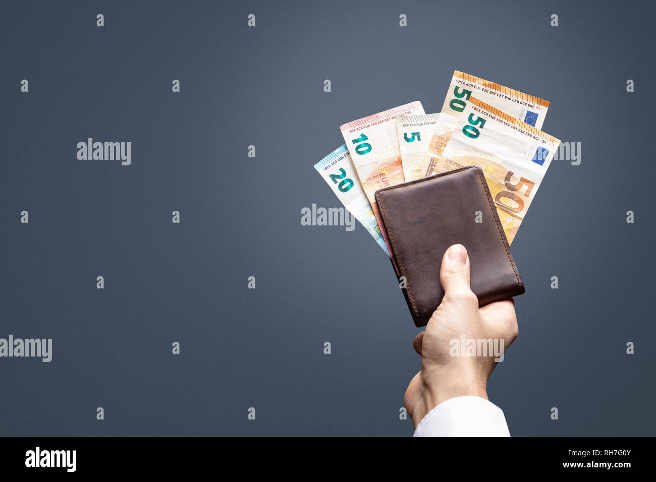 Several Euro banknotes sticking out of a wallet Stock Photo