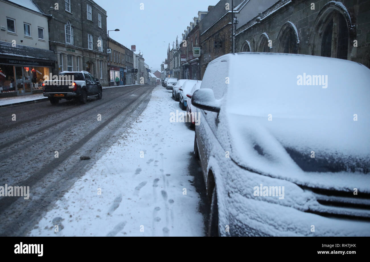 Car makes its way along the high street in shaftesbury hires stock