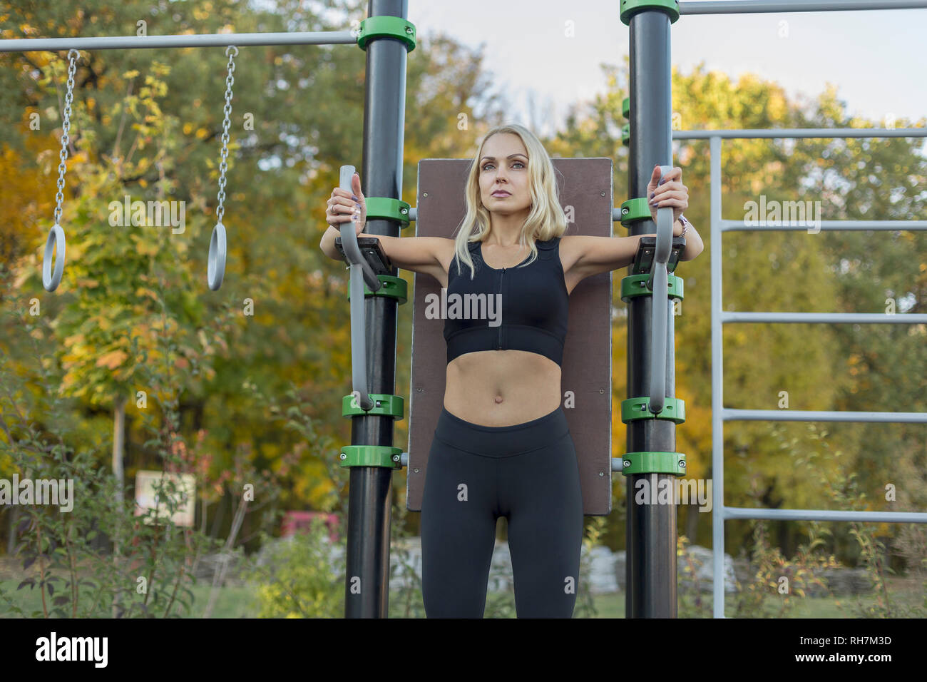 Confident, fit woman exercising in park Stock Photo