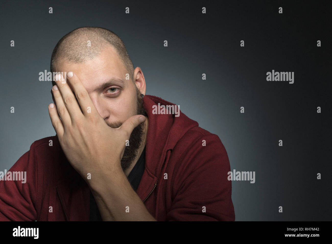 Portrait man covering face with hand Stock Photo