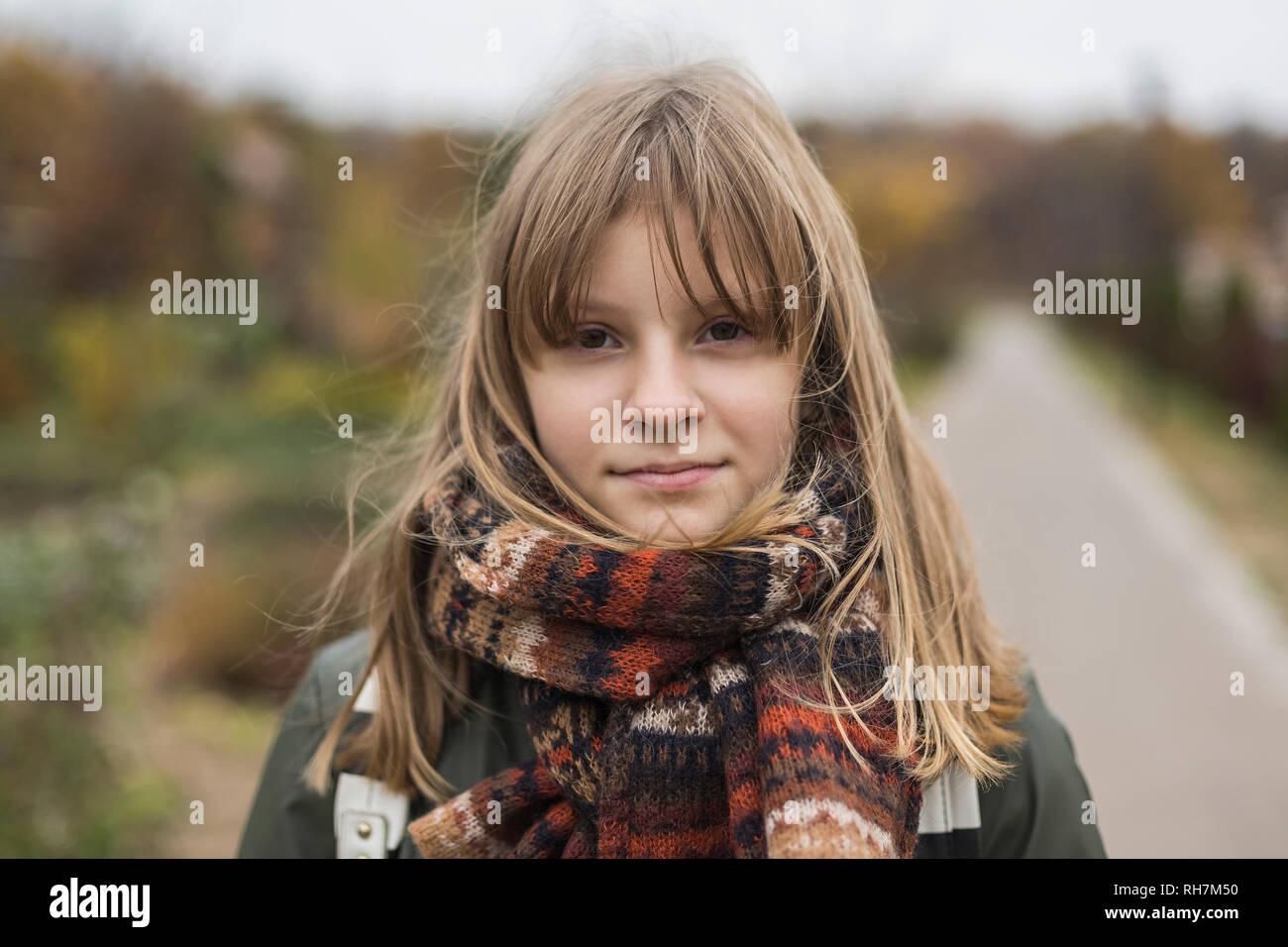Portrait confident tween girl in scarf Stock Photo