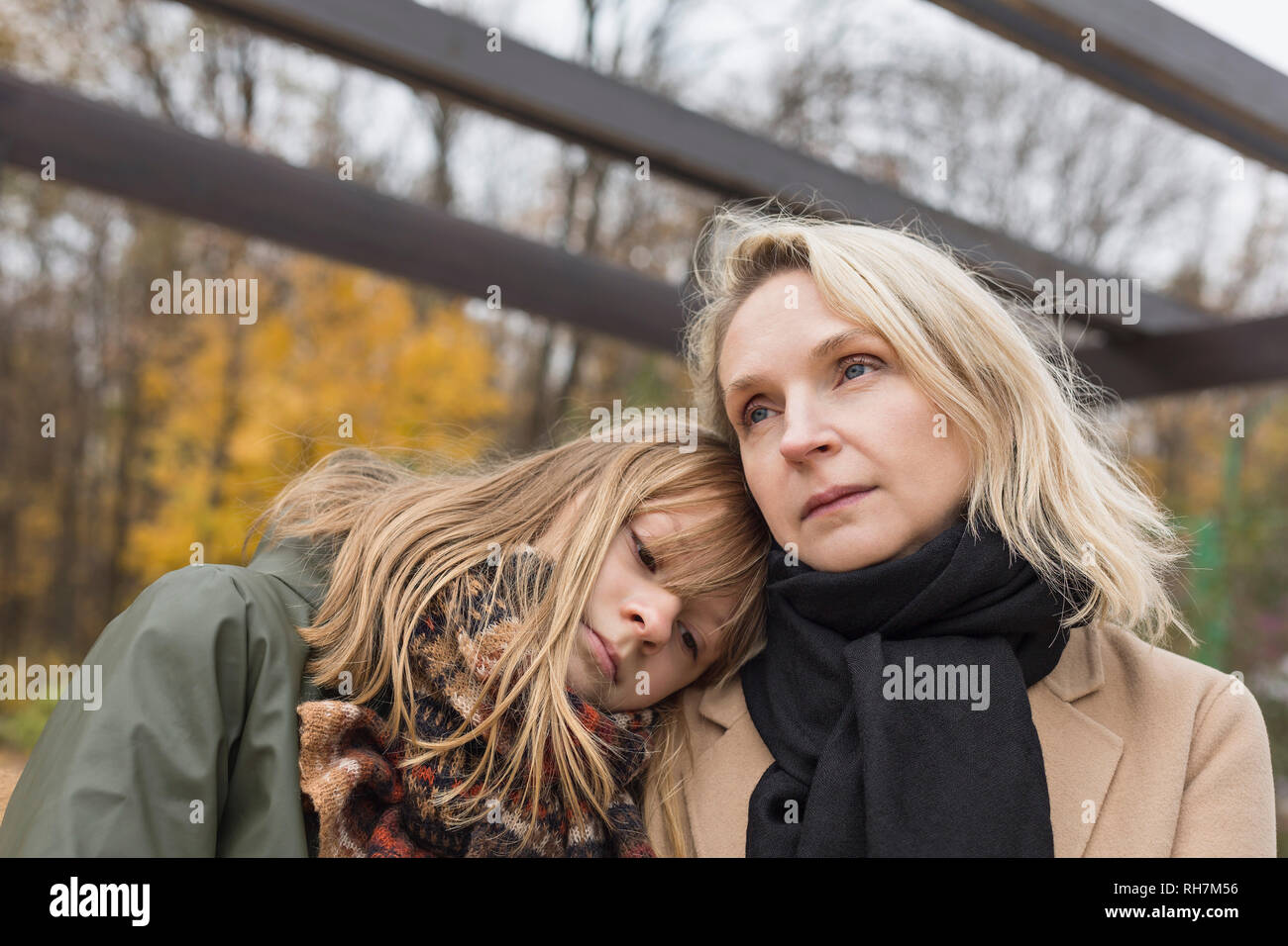 Affectionate, serene mother and daughter in autumn park Stock Photo