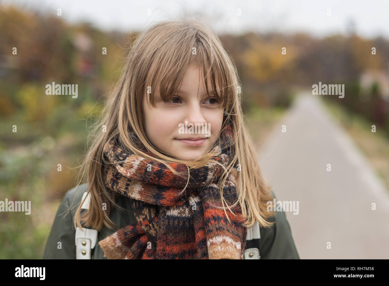 Portrait confident tween girl in scarf Stock Photo