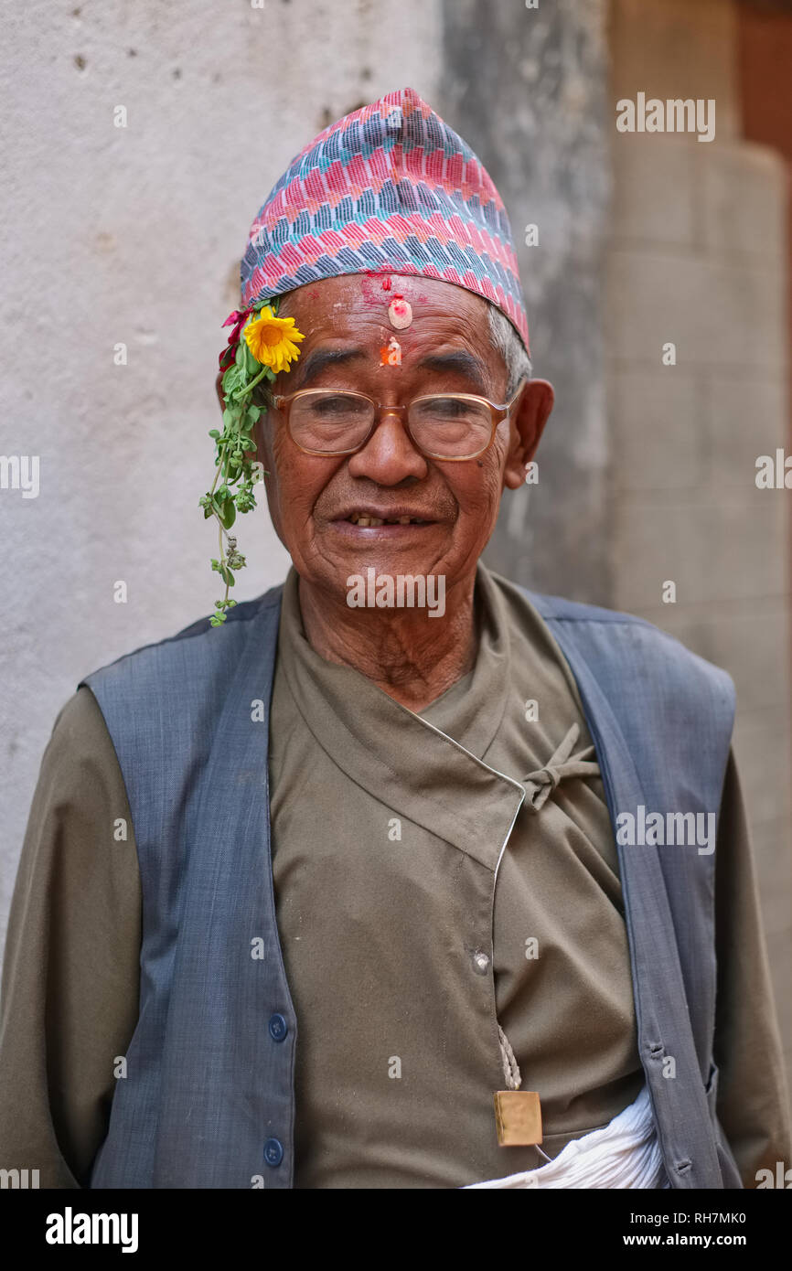 A man of the Newar community in traditional attire, including Nepalese topi (cap),  Bhaktapur, Kathmandu Valley, Nepal Stock Photo