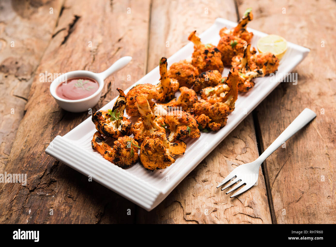 Tandoori Gobi / Roasted cauliflower Tikka is a starter food from India. served with ketchup