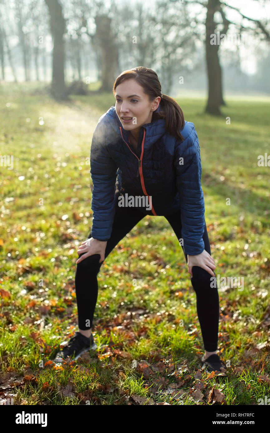 Woman Resting After Morning Exercise With In Winter Park Stock Photo