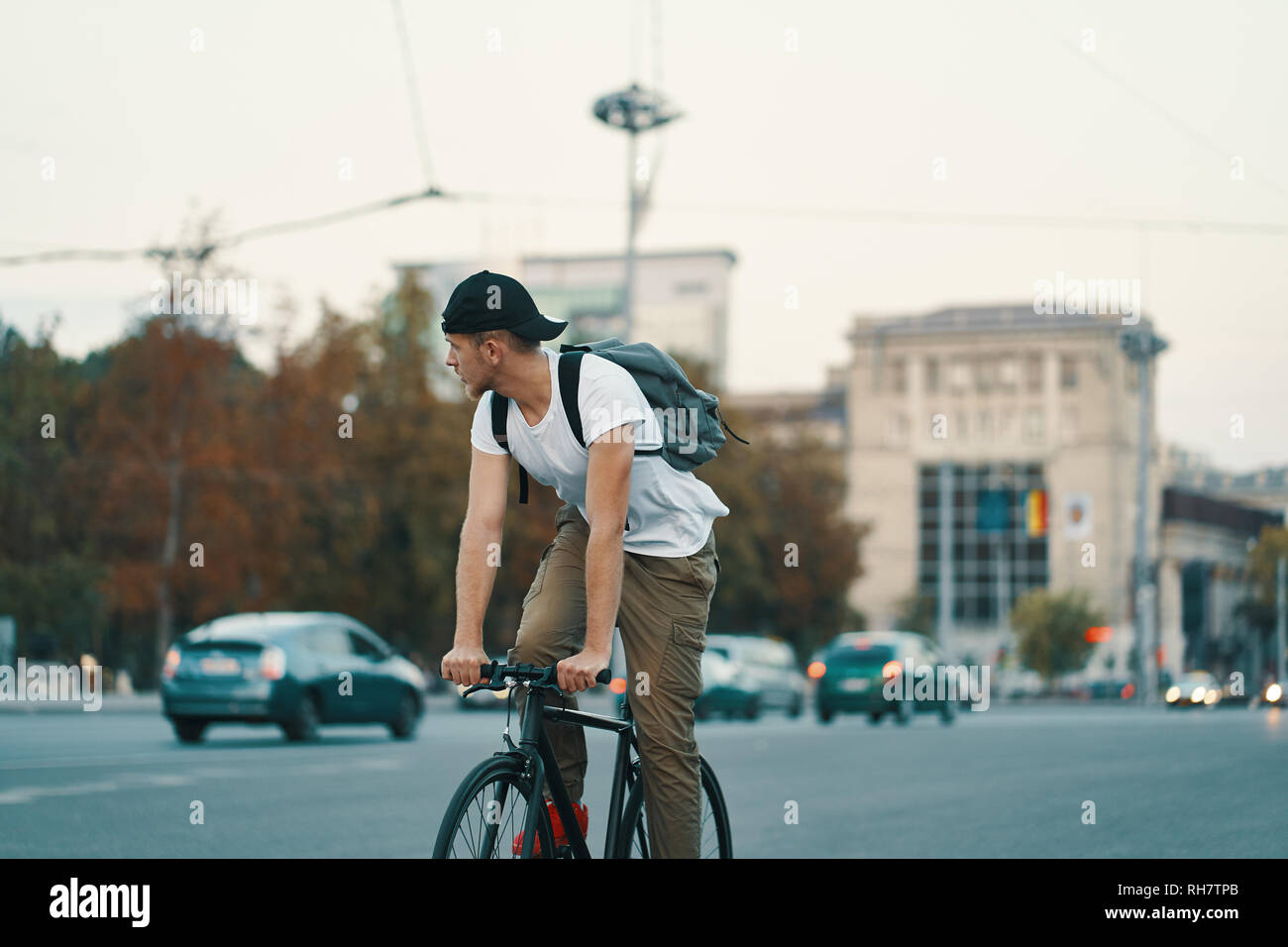 Portrait Of A Young Man Riding On Bicycle In The City Road Street