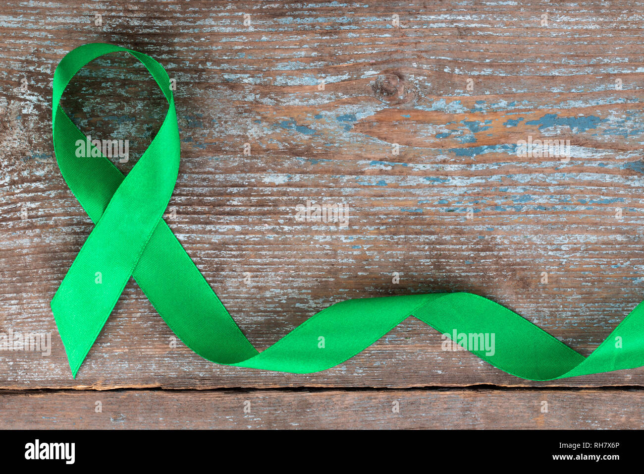 wallpapers Mental Health Logo Green https www alamy com green ribbon scoliosis mental health and other awareness symbo on the wooden background with copy space image234358174 html