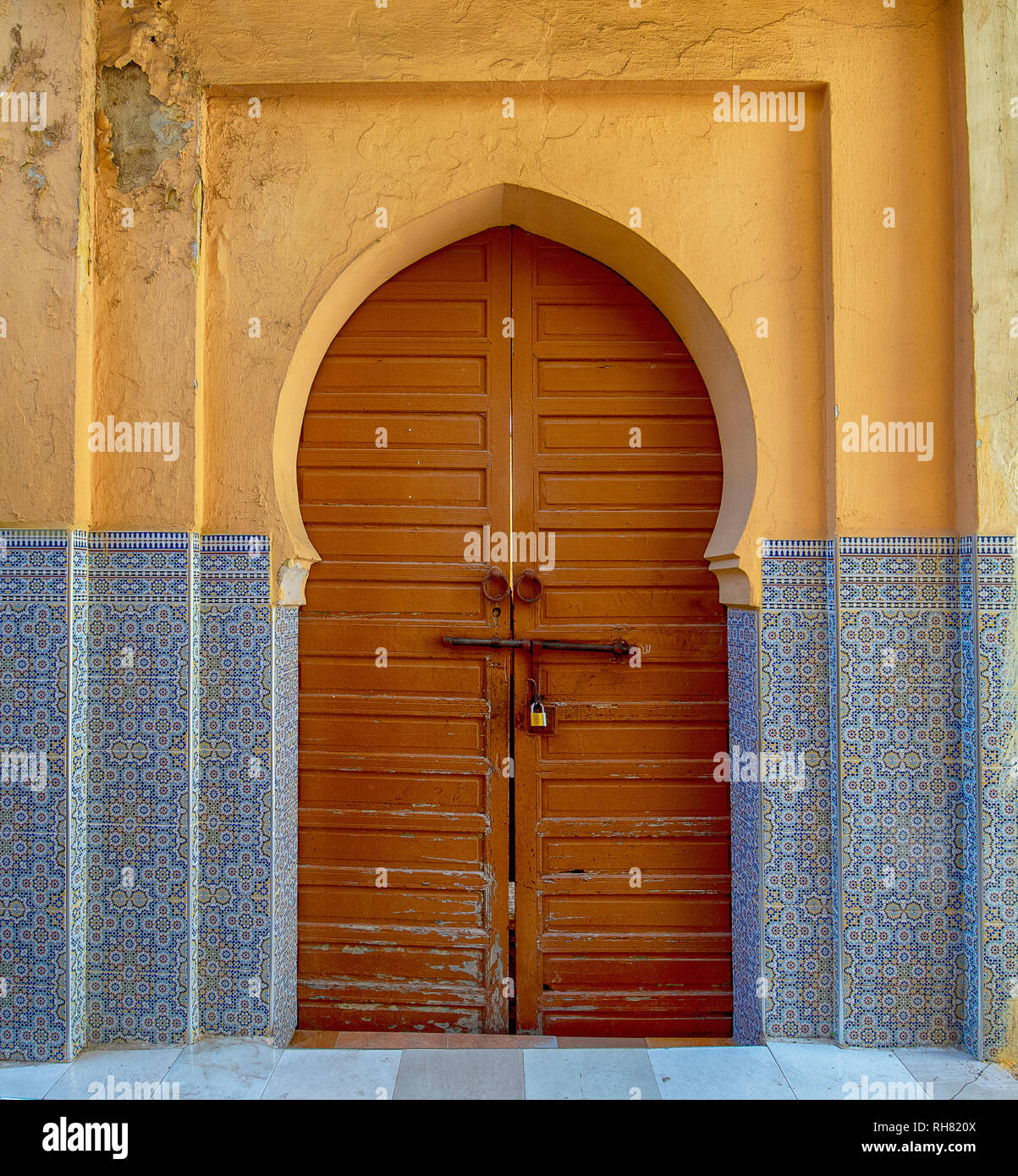 Traditional Moroccan style design of an ancient wooden entry door. In the old Medina. Typical