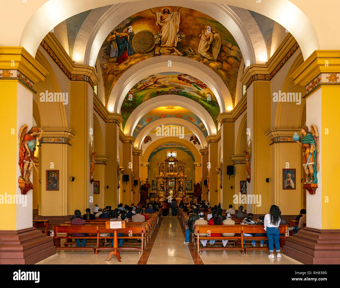 People attending mass inside the baroque style Cathedral Basilica of Saint Mary in Trujillo, Peru. Stock Photo