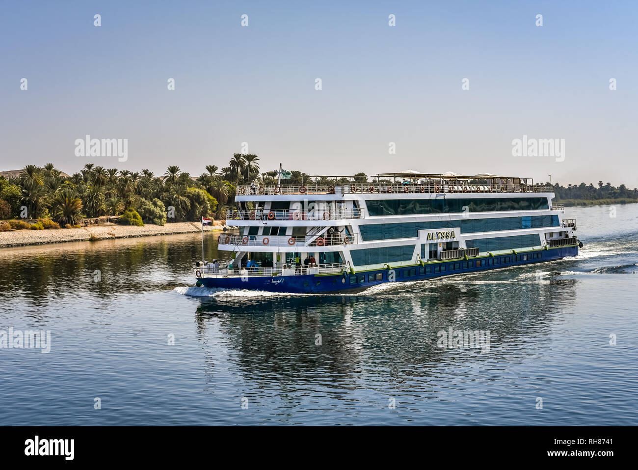 Blue crusing ship with four decks for turists, sailing on the river Nile, Nile, Egypt, October 23, 2018 Stock Photo