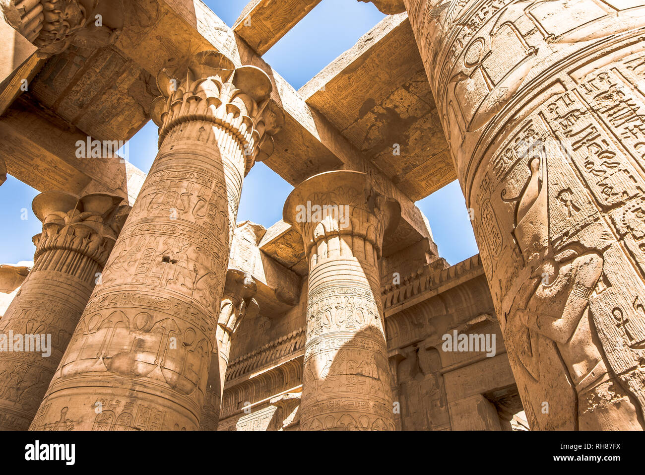 Pillars at the temple of Kom Ombo, decorated with hieroglyphics. The blue  sky is seen through the ceiling, Egypt, October 23, 2018 Stock Photo - Alamy