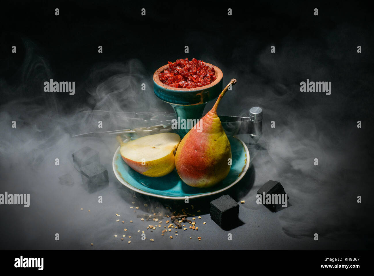 Hookah head full of tobacco molasses decorated with smoke on dark