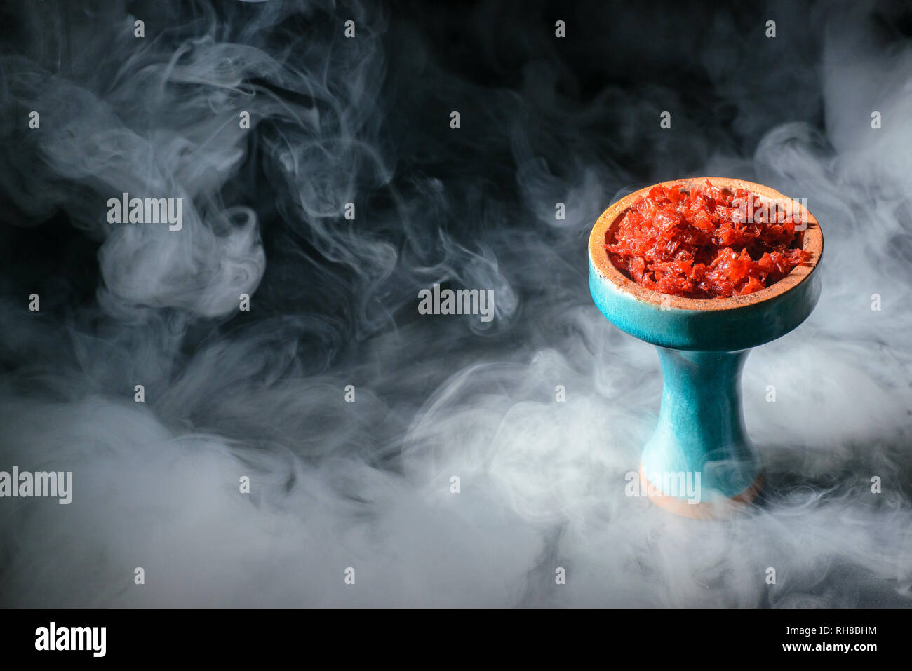 Hookah head full of tobacco molasses decorated with smoke on dark background Stock Photo Alamy