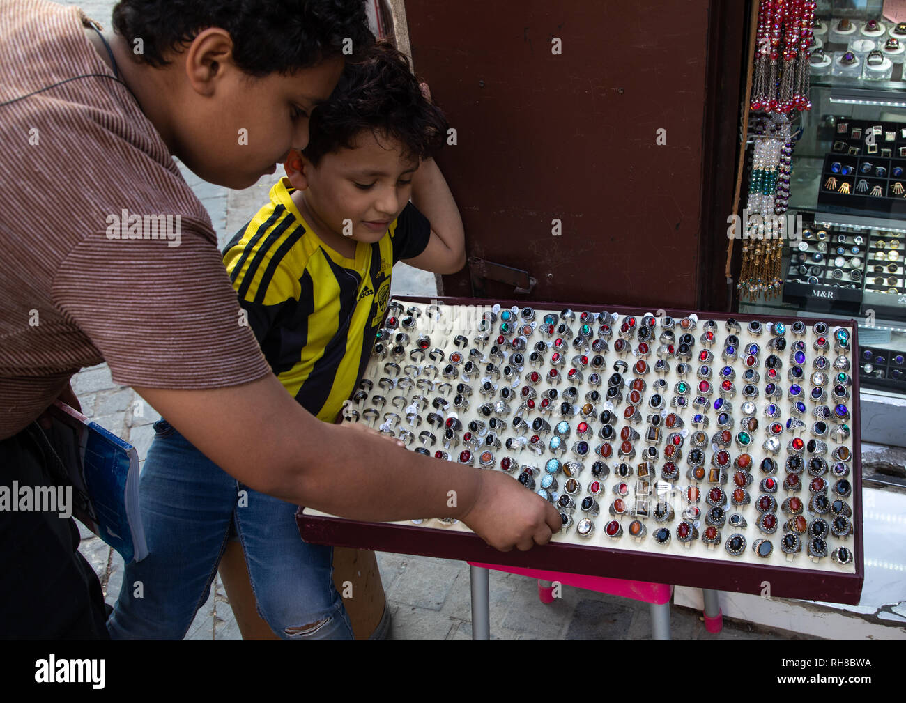 Saudi children looking for rings in a shop, Mecca province, Jeddah, Saudi Arabia Stock Photo