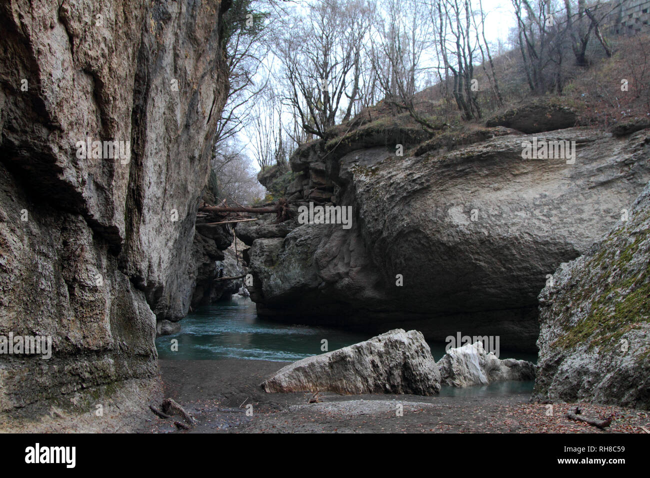 Steep cliffs hang over the water in the Khadzhokhskaya gorge. Stock Photo