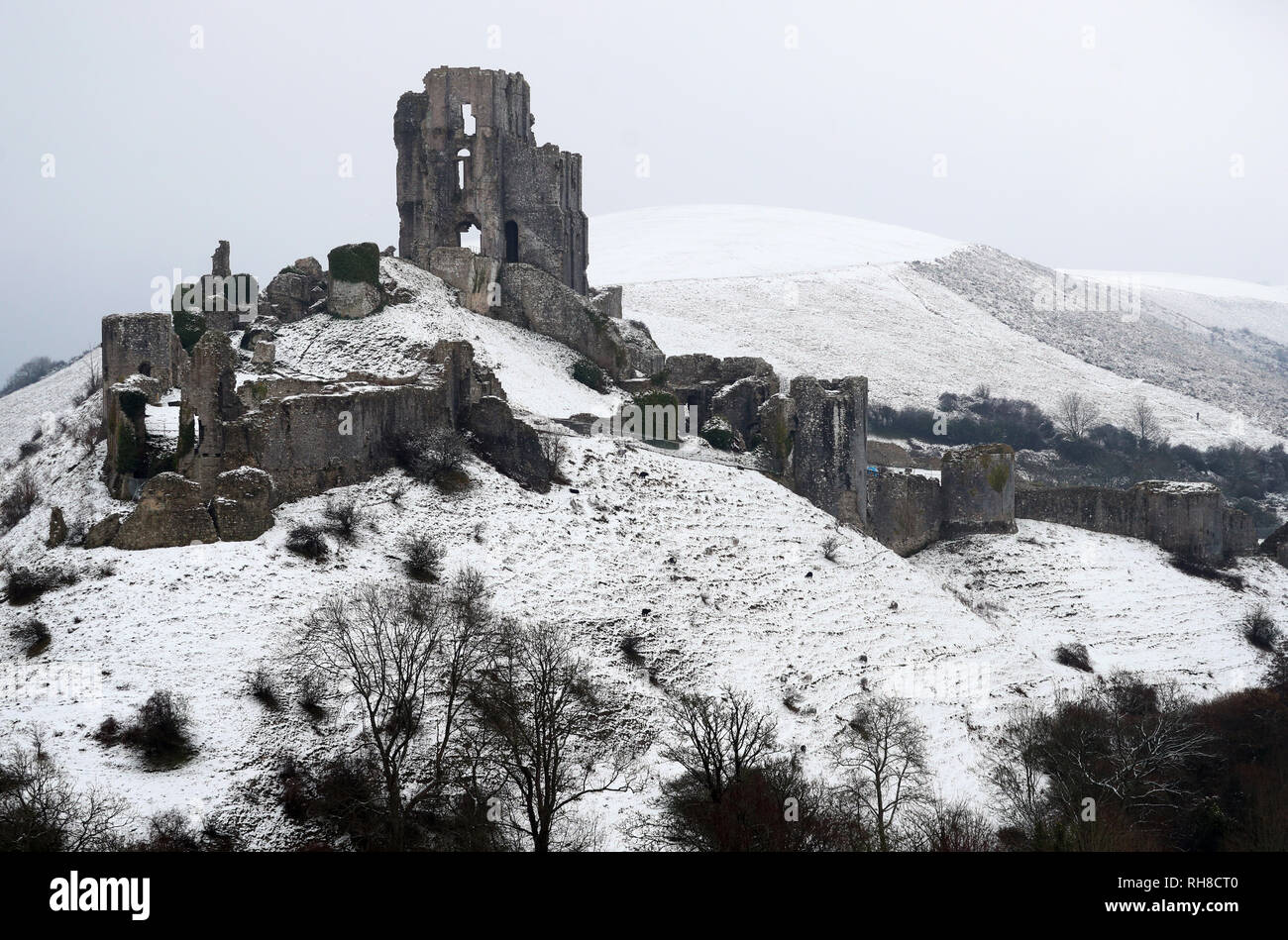 Snow covers the ground around Corfe Castle in Dorset. Snowfall and icy conditions are expected to cause widespread travel disruption after temperatures plummeted as low as minus 15.4C (4.3F) overnight. Stock Photo