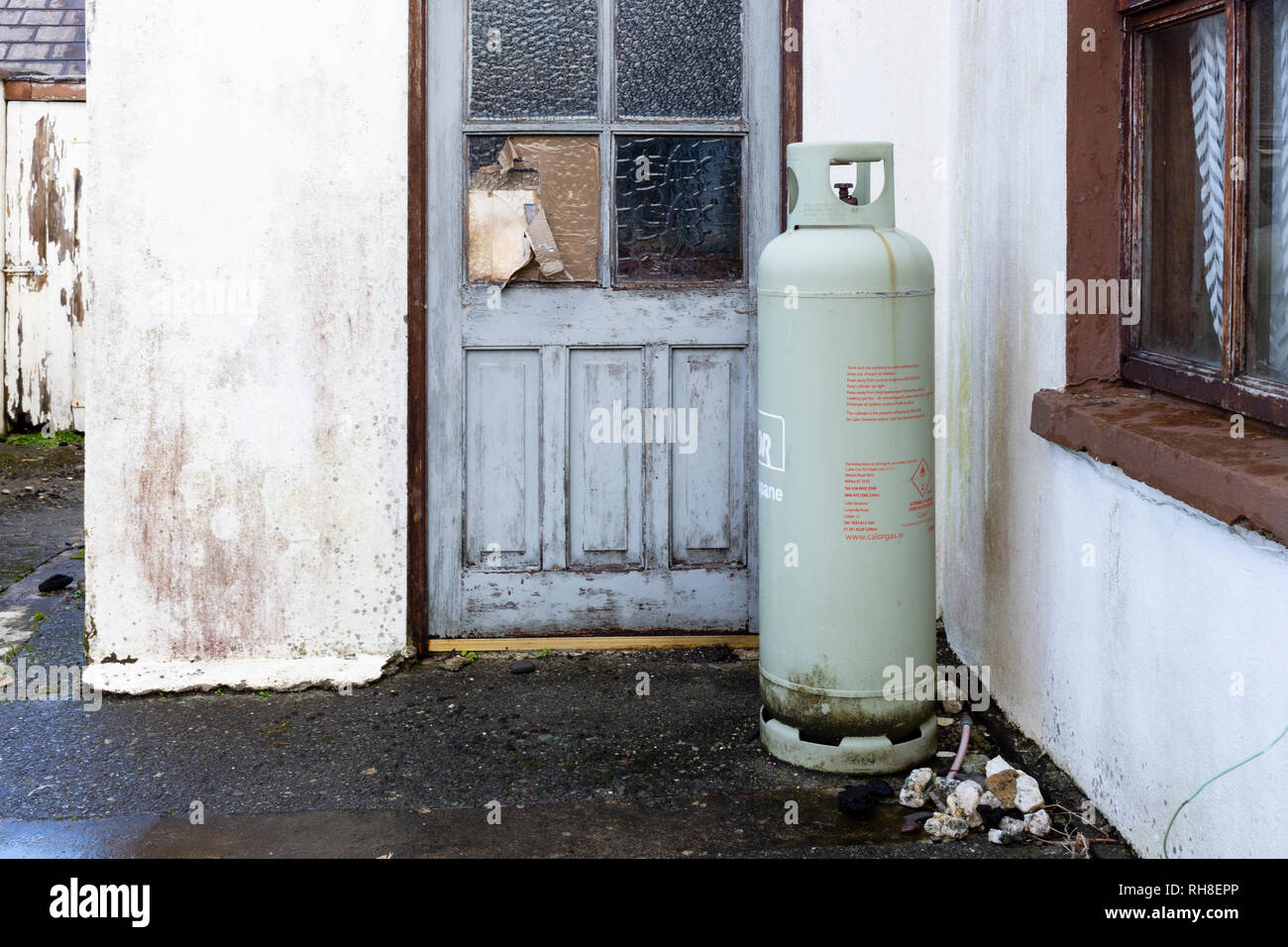 Large domestic gas bottle outside cottage on Valentia Island, county Kerry Ireland Stock Photo