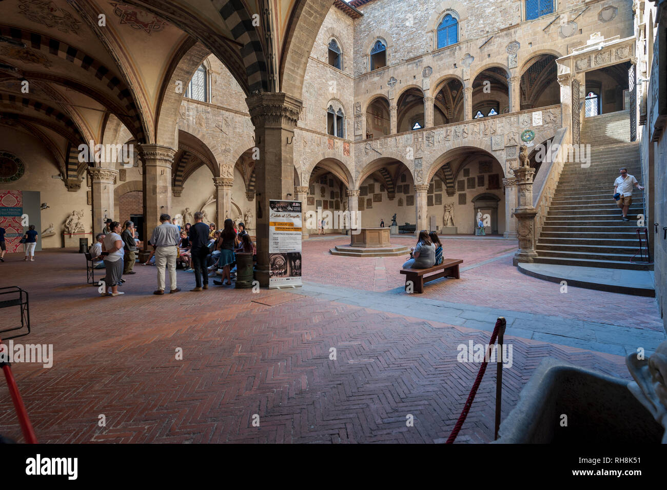 Florence, Italy - 2018, July 1: People pass through the Bargello courtyard. The National Museum has its setting in one of the oldest buildings in Flor Stock Photo