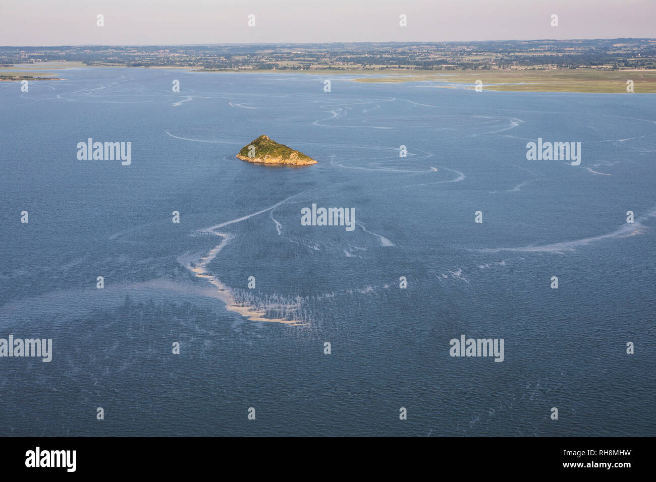 Aerial view of Tombelaine, small tidal island, at high tide, in the bay of Le Mont-Saint-Michel (St Michael's Mount) in Normandy, north-western France Stock Photo