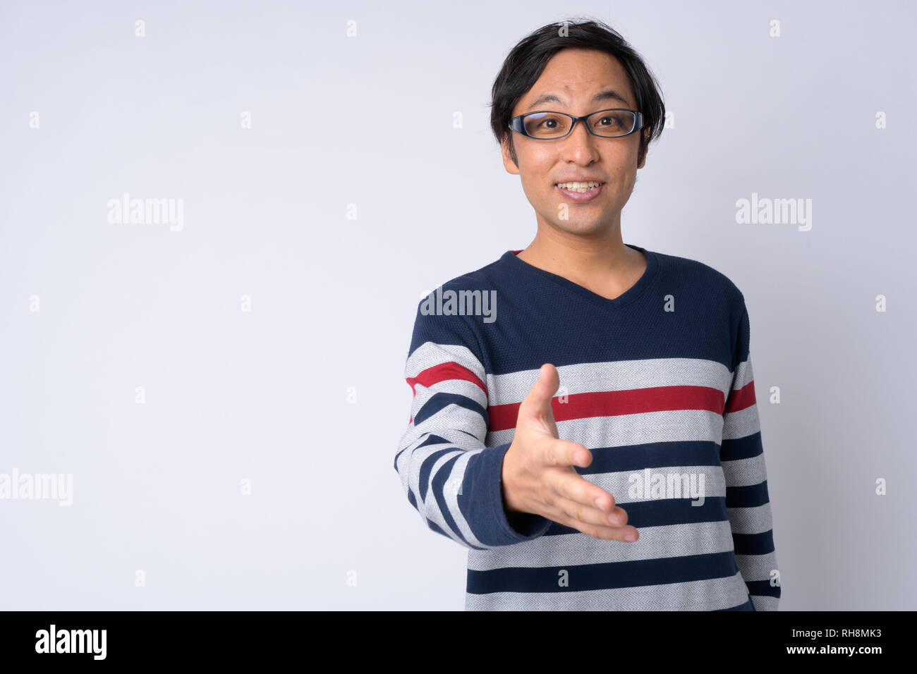 Portrait of happy Japanese man giving handshake Stock Photo - Alamy