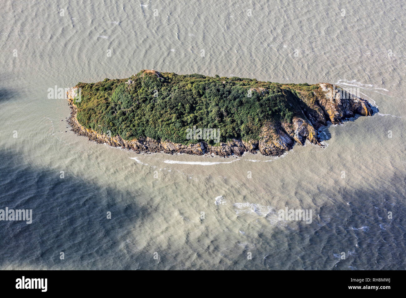 Aerial view of Tombelaine, small tidal island, at high tide, in the bay of Le Mont-Saint-Michel (St Michael's Mount) in Normandy, north-western France Stock Photo
