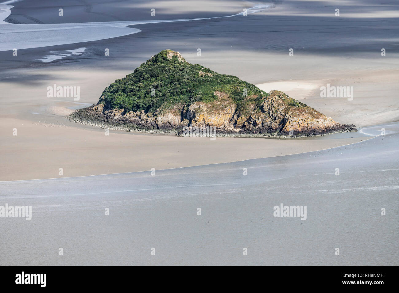 Aerial view of Tombelaine, small tidal island, at rising tide, in the bay of Le Mont-Saint-Michel (St Michael's Mount) in Normandy, north-western Fran Stock Photo