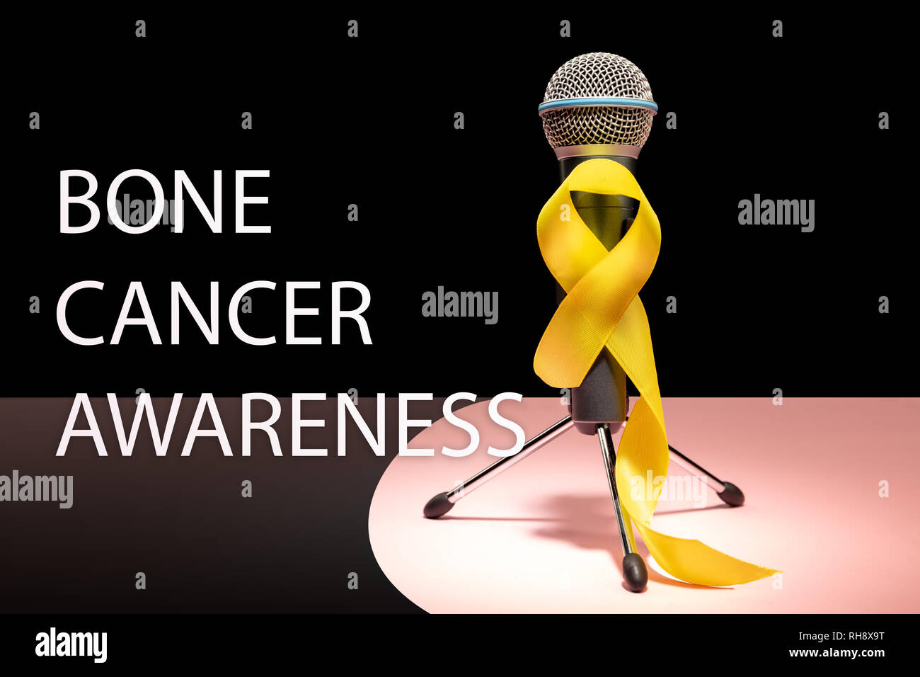 Yellow ribbon symbolic color for Sarcoma Bone cancer awareness and suicide prevention with microphone. The cancer, health, help, care, support, hope, illness, healthcare concept Stock Photo