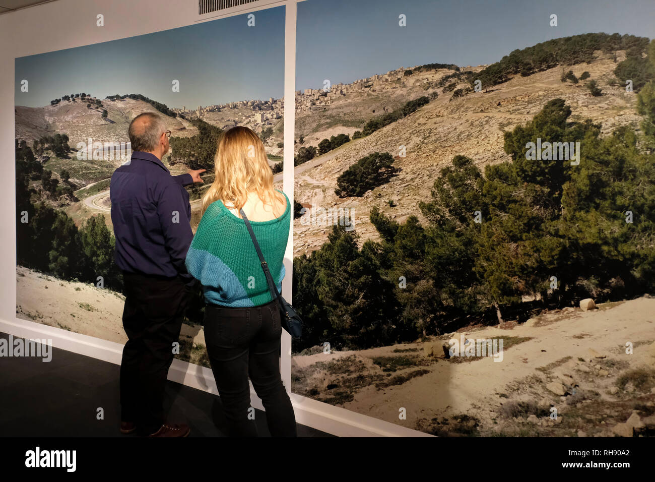 Jerusalem Israel, 01 February 2019. Israeli visitors view the work of Israeli photographer and artist Yaakov Israel entitled 'Legitimacy of Landscape' exhibited at the Museum for Islamic Art in West Jerusalem Israel. The exhibition provokes thought about places that have been forgotten in Israeli society and summarizes a 16 year project during which Yaakov took photographs of Arab, Bedouin and Druze villages in Israel and the Occupied Territories, a sort of voyage through the sociopolitical landscapes of the country. Stock Photo