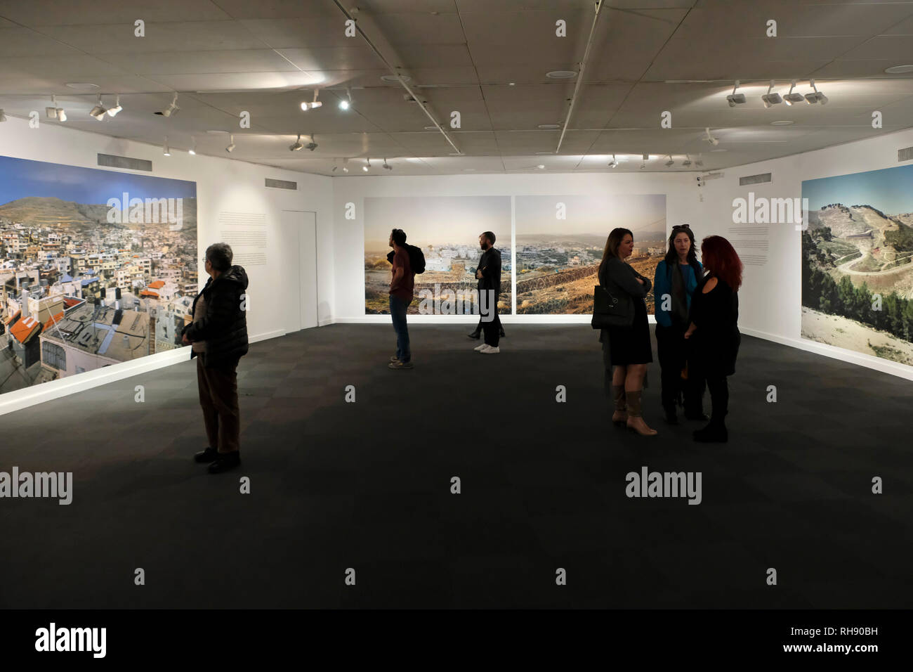 Jerusalem Israel, 01 February 2019. Israeli visitors view the work of Israeli photographer and artist Yaakov Israel entitled 'Legitimacy of Landscape' exhibited at the Museum for Islamic Art in West Jerusalem Israel. The exhibition provokes thought about places that have been forgotten in Israeli society and summarizes a 16 year project during which Yaakov took photographs of Arab, Bedouin and Druze villages in Israel and the Occupied Territories, a sort of voyage through the sociopolitical landscapes of the country. Stock Photo