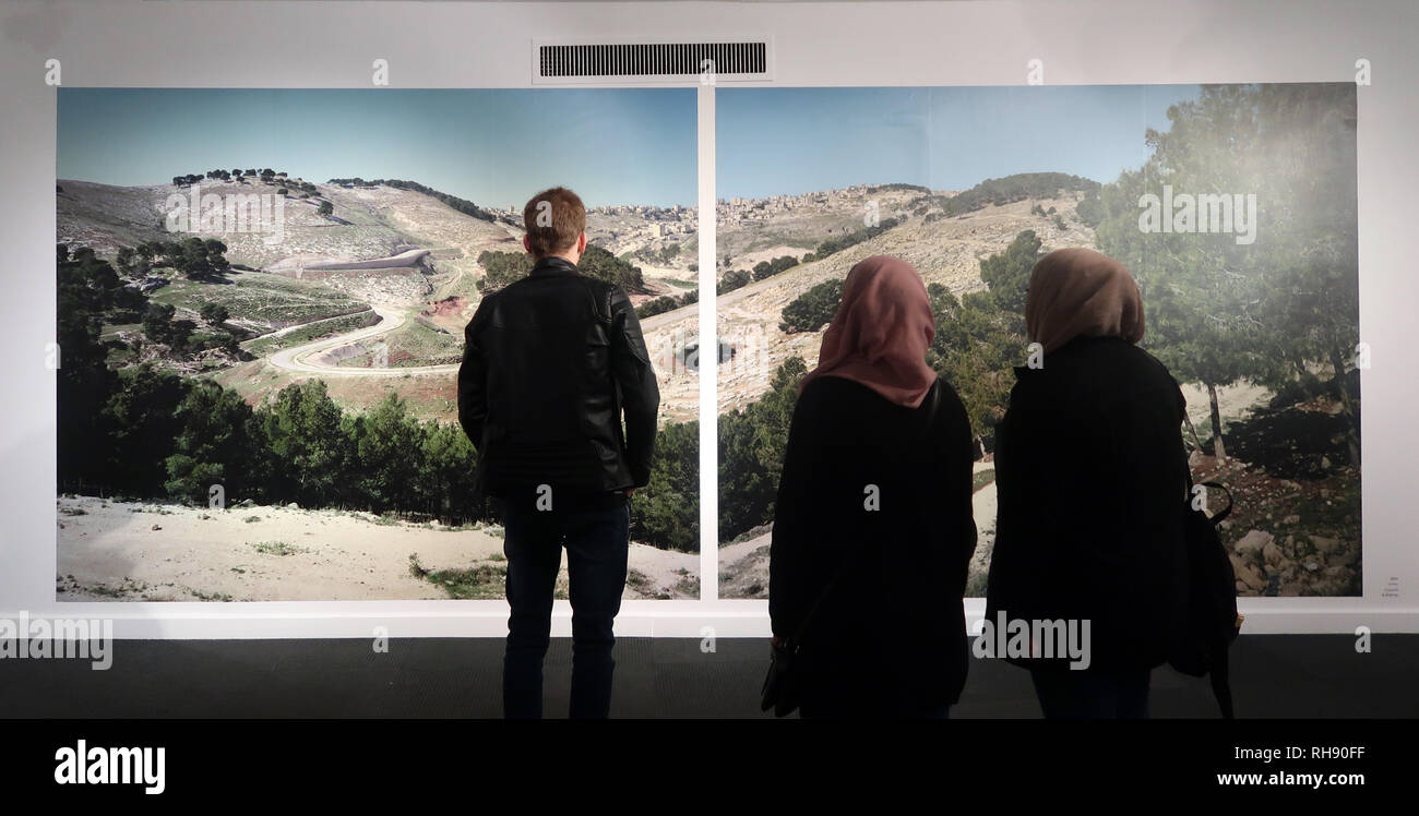 Jerusalem Israel, 01 February 2019. Palestinian and Israeli visitors view the work of Israeli photographer and artist Yaakov Israel entitled 'Legitimacy of Landscape' exhibited at the Museum for Islamic Art in West Jerusalem Israel. The exhibition provokes thought about places that have been forgotten in Israeli society and summarizes a 16 year project during which Yaakov took photographs of Arab, Bedouin and Druze villages in Israel and the Occupied Territories, a sort of voyage through the sociopolitical landscapes of the country. Stock Photo