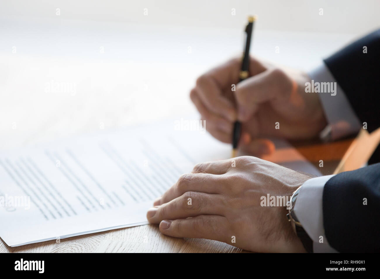 Close up view of male hand signing business contract concept Stock ...