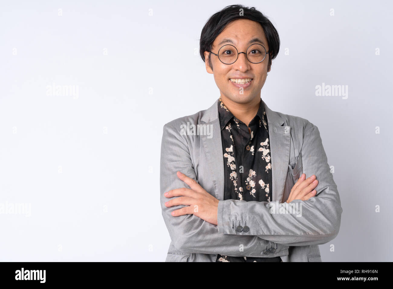 Portrait of happy Japanese businessman smiling with arms crossed Stock ...
