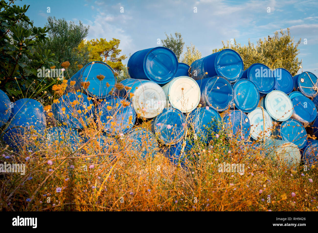 Used blue plastic drums for storing water and other liquids is washed up by  the sea on sandy beach, waste Stock Photo - Alamy