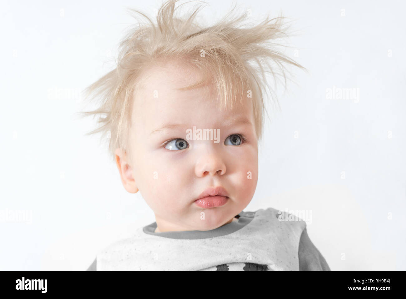 cute sleepy disheveled child with interrogative face. Stock Photo
