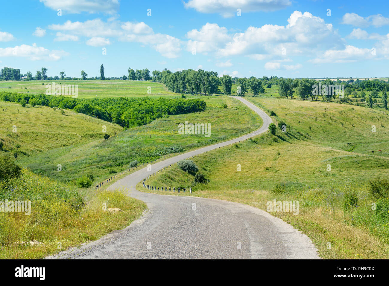 Winding road among fields in picturesque countryside Stock Photo Alamy