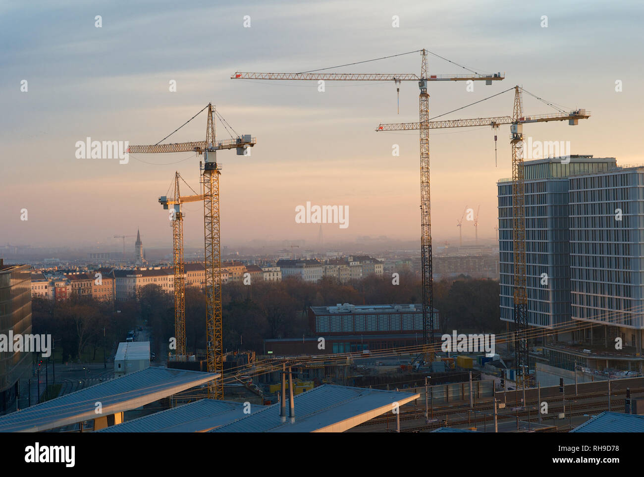 Construction Cranes at Sunrise with the Famous Skyline of Central Vienna Stock Photo