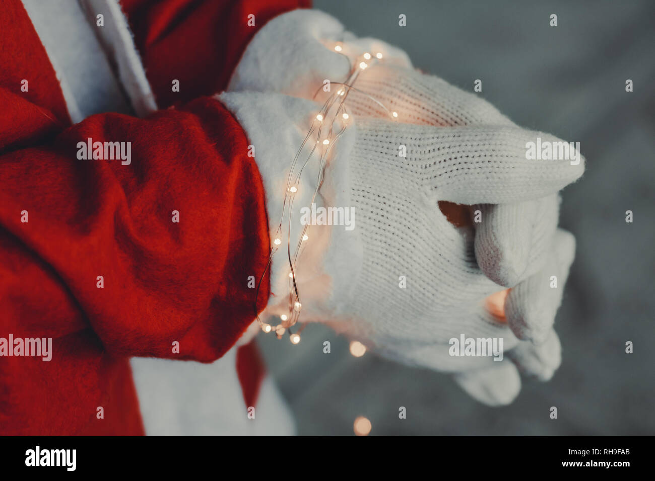 hands of santa claus chained with illuminated led lights Stock Photo