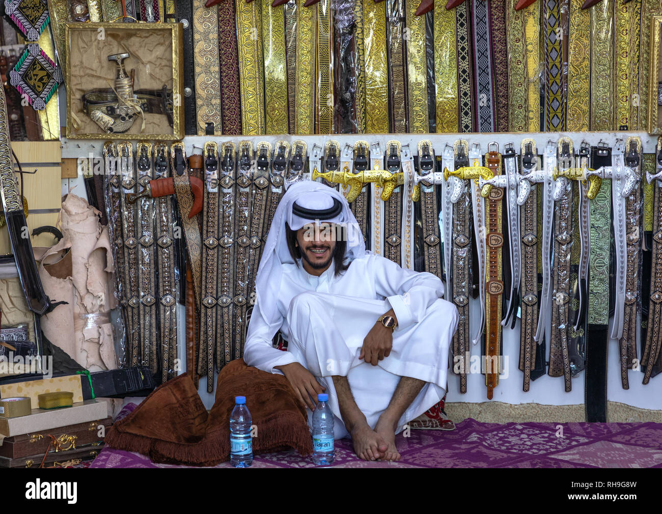 Saudi man selling belts and  janbiya daggers, Najran Province, Najran, Saudi Arabia Stock Photo