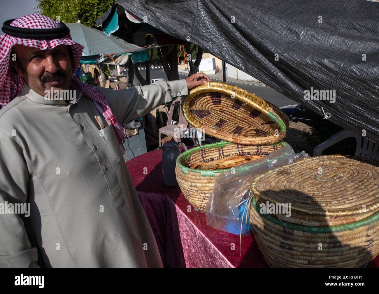 Saudi man buying bread in the women market, Asir province, Abha, Saudi Arabia Stock Photo